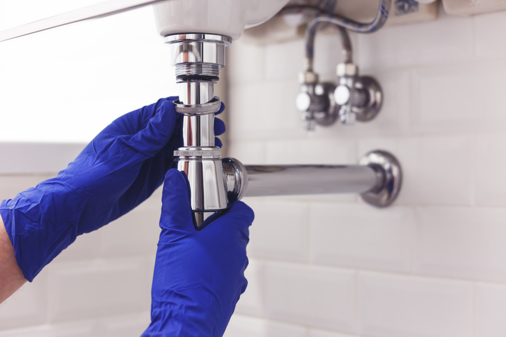 Plumber,Repairs,And,Maintains,Chrome,Siphon,Under,The,Washbasin.,Plumber